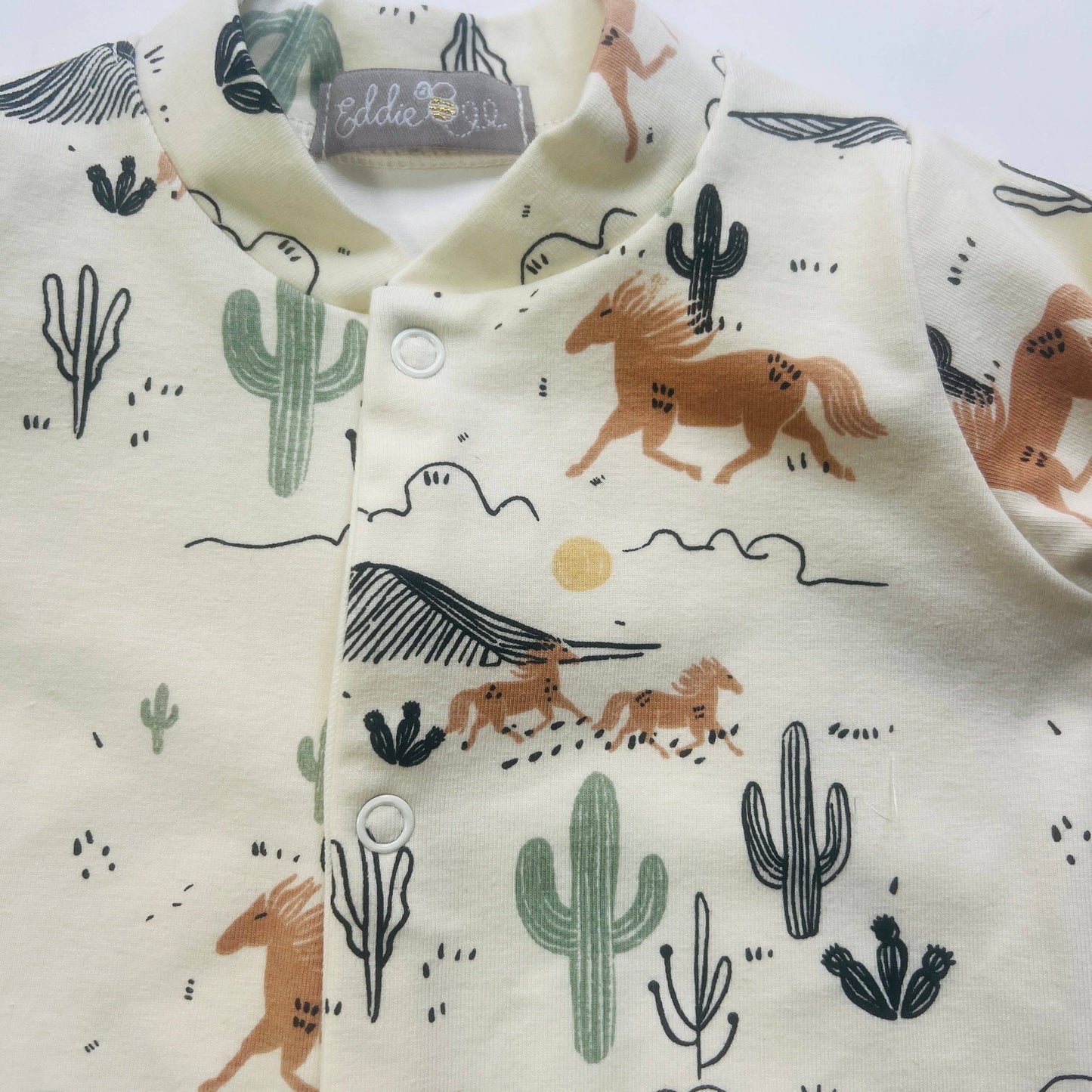 Eddie & Bee organic cotton Baby sleepsuit  in Cream " Wild West " print.